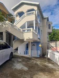 a white car parked in front of a house at Villa village 02 in Saint Lucia Island