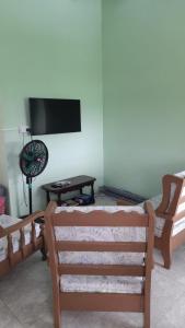 a living room with two chairs and a flat screen tv at Villa village 02 in Saint Lucia Island