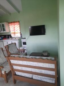 a living room with a couch and a flat screen tv at Villa village 02 in Saint Lucia Island +4 photos