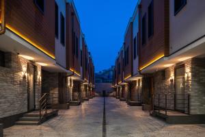 an alley between two buildings with lights on at IGMAR Villas & Aparts Hotel in Tashkent