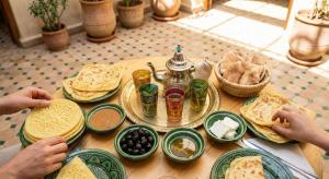 a wooden table with plates of food on it at Stylish Moroccan Apartment in Marrakesh