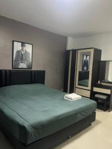 a bedroom with a green bed and a piano at Escobar guest house jomtien in Ban Nong Tabaek +3 photos