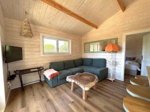 a living room with a blue couch and a table at Cabana in Sesimbra