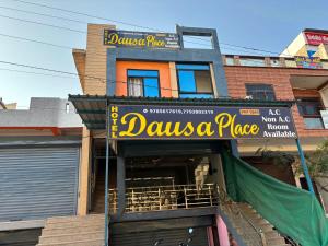 a building with a sign that reads davis a place at Hotel Dausa Place in Dausa