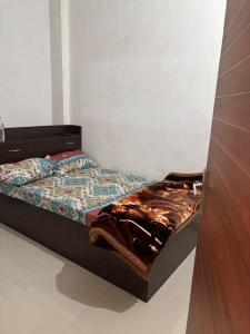 a bed in a room with a bed sqor at Hotel Dausa Place in Dausa