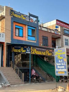 a building with signs in front of it at Hotel Dausa Place in Dausa