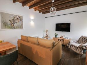 a living room with a couch and a tv at The Loft in Kilkenny