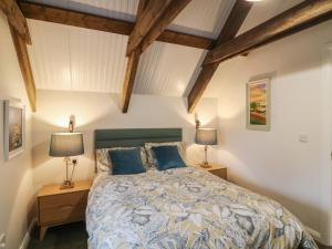 a bedroom with a bed and two lamps on tables at The Loft in Kilkenny