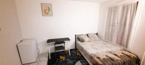 a small room with a bed and a stool in it at Havre De Paix Réside in Le Mée-sur-Seine +1 photo