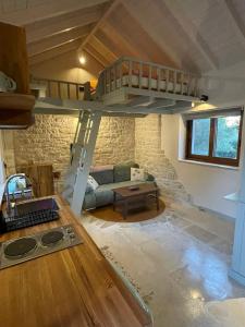 a living room with a loft bed in a house at Mikro kastro in Apergátika