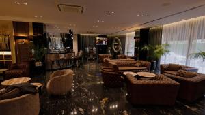 a lobby with couches and tables and a bar at Hotel Royal Plovdiv in Plovdiv