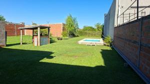 a backyard with a swimming pool and a gazebo at Chacra Arcoiris in Gualeguay