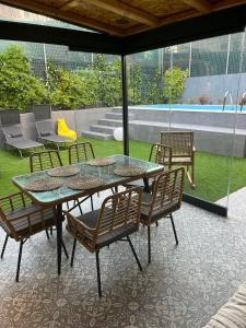 a patio with a table and chairs and a pool at Trinity Gythion in Gythio
