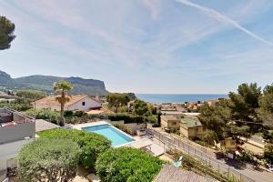 a villa with a swimming pool and a view of the ocean at Home Cassis - Maison Méditerranée - Piscine chauffée à 30c in Cassis