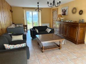 a living room with couches and a coffee table at Gîte la Chenevière in Étueffont
