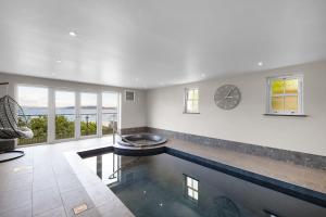 a living room with a pool of water and a clock at Finest Retreats - Bownder House in Cawsand