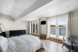 a bedroom with a bed and a view of the ocean at Finest Retreats - Bownder House in Cawsand +32 photos