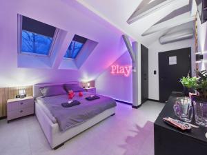 a purple bedroom with a bed and a neon sign at Romantic Studio Marki LoveAparts in Marki
