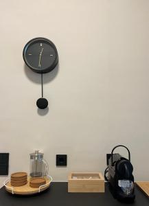 a clock hanging on a wall next to a counter at Trinity Gythion in Gythio