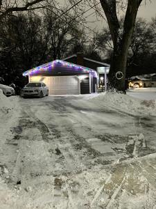 a car parked in front of a garage in the snow at MidwestBNB Room1, quite cabin in the wood vibes in Minneapolis