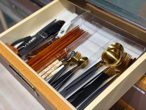 a drawer full of utensils in a wooden box at Tasogare in Kihokucho