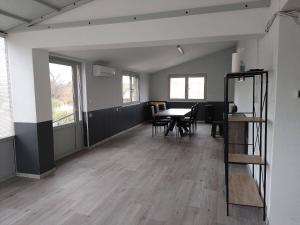 an empty room with a table and chairs at Gîte L'Olivier - Piscine partagée in Lagorce