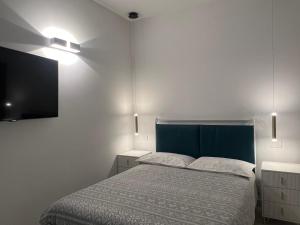 a bedroom with a bed and a flat screen tv at Casa nel vicolo in Montichiari