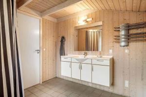 a bathroom with a sink and a mirror at JB406-Fjerritslev-Aspevej-68 in Fjerritslev +16 photos