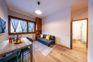 a living room with a couch and a table at Eco Home - Val di Luce in Abetone