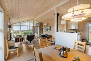 a kitchen and living room with a table and chairs at JB406-Fjerritslev-Aspevej-68 in Fjerritslev