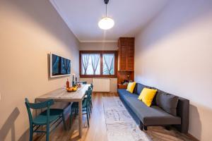 a living room with a couch and a table at Eco Home - Val di Luce in Abetone