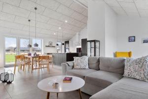 a living room with a couch and a table at 20514-Samso-Plantagevej-17 in Sælvig