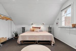 a bedroom with a large bed in a white room at 20427-Samso-Torup-13 in Torup