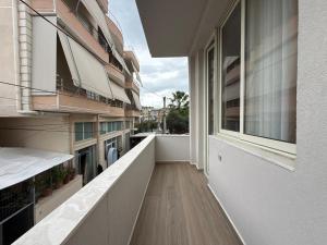 an empty balcony of a building with a window at Guest House Deon in Vlorë