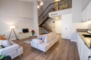 a living room with two couches and a staircase at Myway Deluxe Hotel in Konak +23 photos