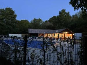 a building with a fence in front of it at Lodge Mini-Wood in Les Rochettes
