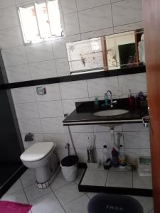 a small bathroom with a toilet and a sink at Casa Branca in Vila Velha +13 photos