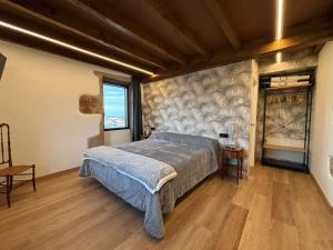 a bedroom with a large bed and a window at Casa do Cabo in Morás