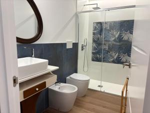 a bathroom with a toilet and a sink and a shower at Casa do Cabo in Morás