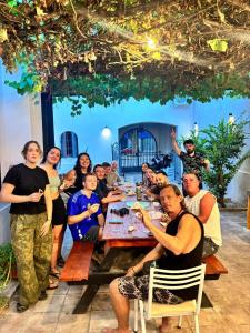 a large group of people sitting around a table at Hostel Plaza in Mendoza