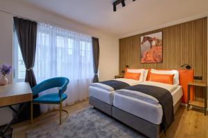 a hotel room with a bed and a desk at Franziskaner by Centra in Zurich