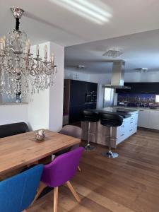 a kitchen and dining room with a chandelier at Bright & Cozy Apartment in Villach
