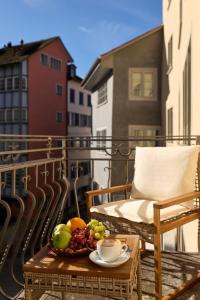a table with a bowl of fruit on a balcony at Franziskaner by Centra in Zurich