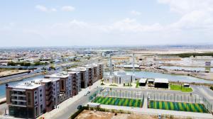 an aerial view of a city with a river and buildings at WAAFI LA CORNICHE RESIDENCE in Djibouti +11 photos