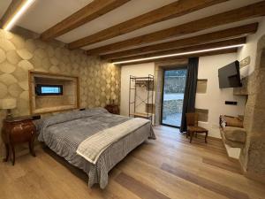 a bedroom with a bed and a large window at Casa do Cabo in Morás