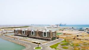 an aerial view of a building next to the ocean at WAAFI LA CORNICHE RESIDENCE in Djibouti