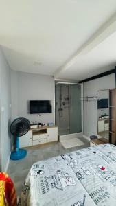 a bedroom with a large bed and a shower at Kitjamyhome1 in Hat Yai