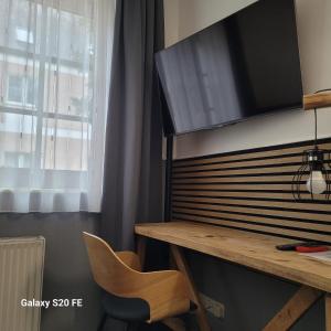 a room with a desk and a television on a wall at Parkhotel Schwedt in Schwedt +35 photos