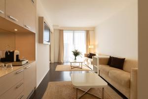 a living room with a couch and a table at Laguna Palace Hotel Grado in Grado