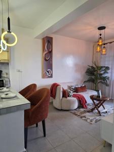 a living room with a couch and a table at Rio Cabins in Nyeri